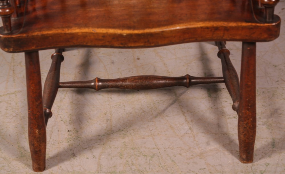 A high-back Scottish Darvel Windsor armchair crafted from warm brown wood, featuring a comb crest rail, spindle back, curved arm bow, and saddle seat. View IX