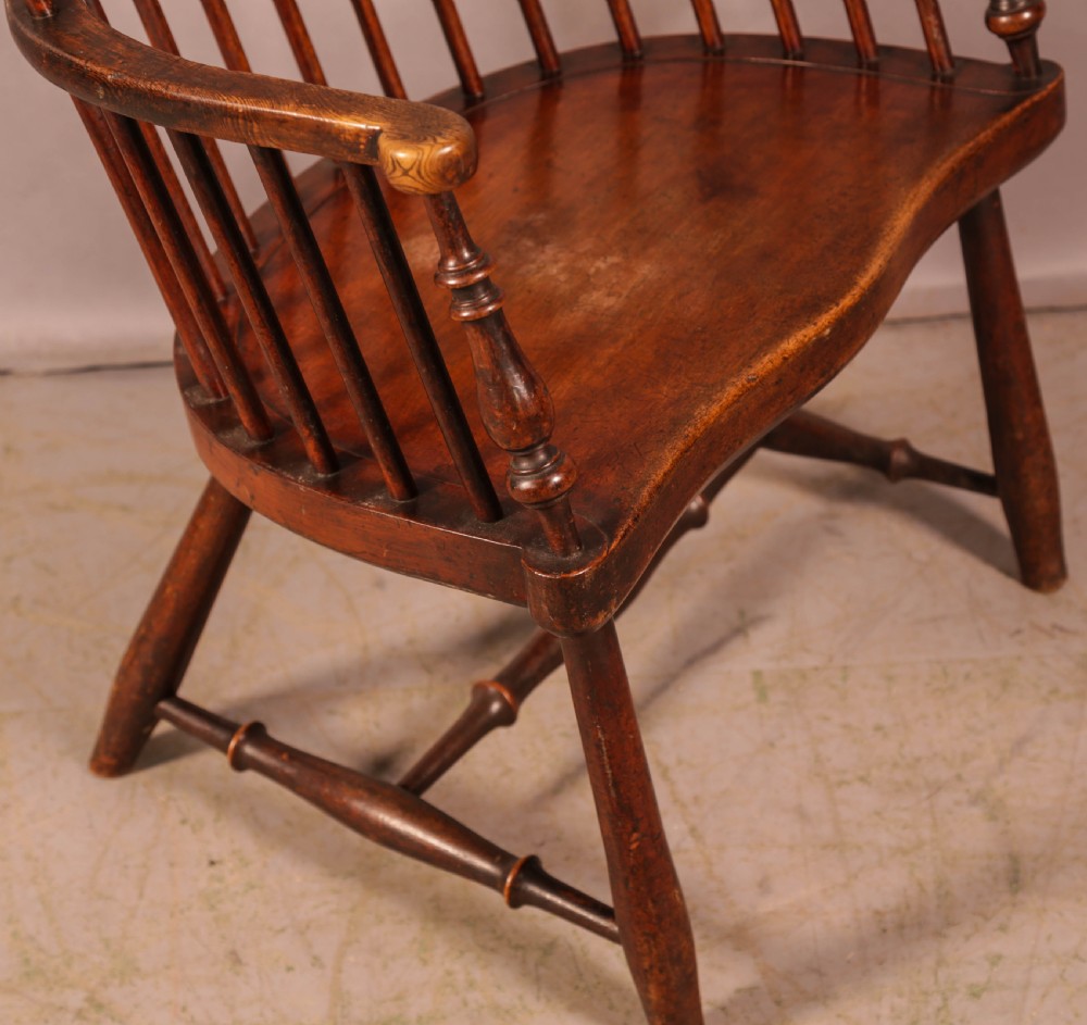 A high-back Scottish Darvel Windsor armchair crafted from warm brown wood, featuring a comb crest rail, spindle back, curved arm bow, and saddle seat. View XI