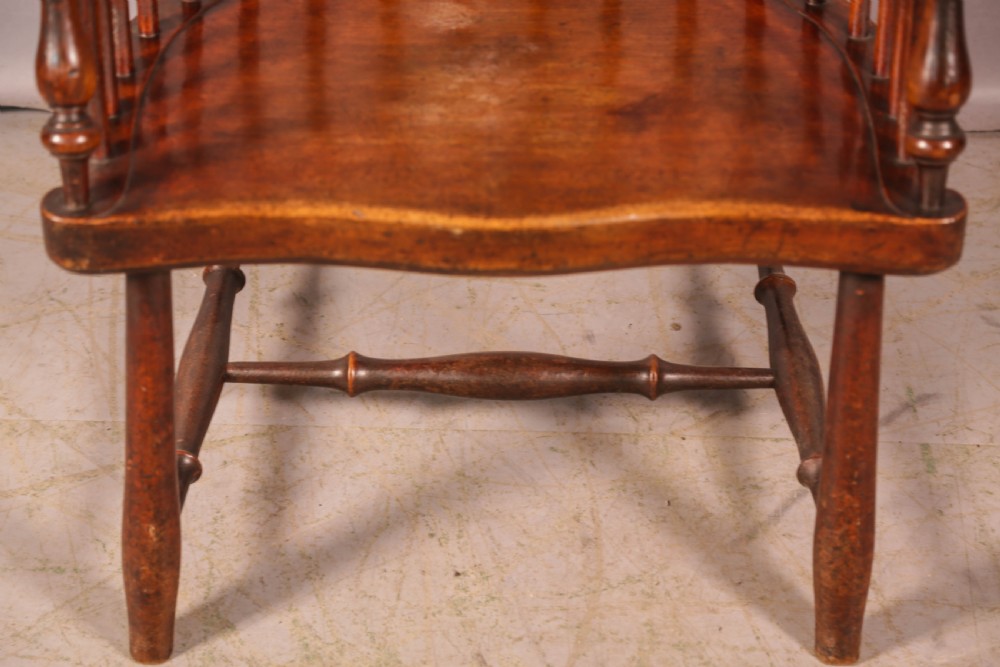 A high-back Scottish Darvel Windsor armchair crafted from warm brown wood, featuring a comb crest rail, spindle back, curved arm bow, and saddle seat. View XII