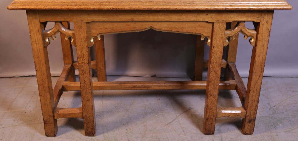A 19th-century oak Gothic Revival serving table featuring carved pointed arch spandrels and a low box stretcher. View III