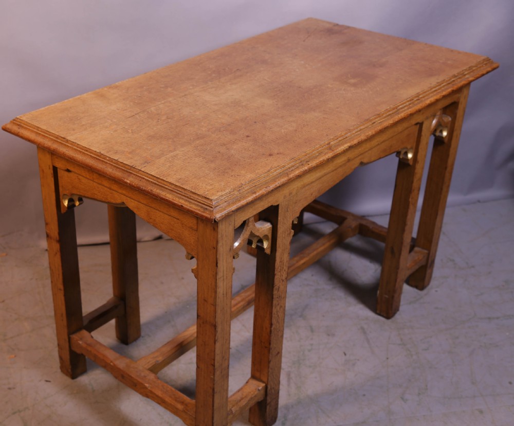 A 19th-century oak Gothic Revival serving table featuring carved pointed arch spandrels and a low box stretcher. View VI