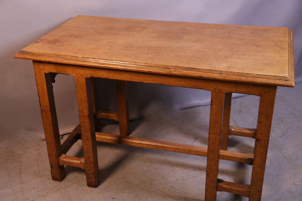A 19th-century oak Gothic Revival serving table featuring carved pointed arch spandrels and a low box stretcher. View VIII