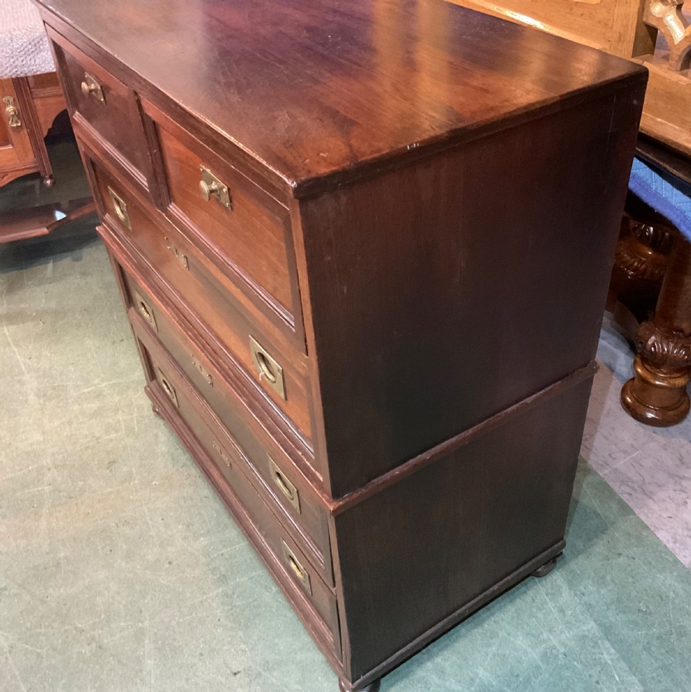 An antique padouk wood campaign chest of drawers featuring two short over three long drawers with recessed brass handles and turned feet. View III