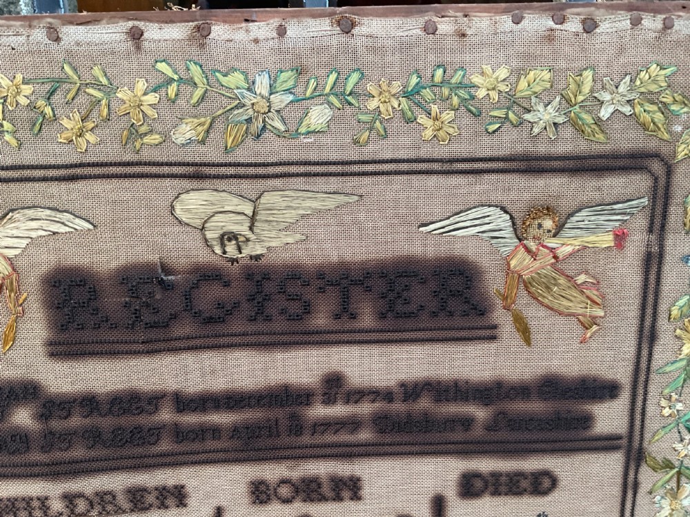 An 1832 Georgian embroidered linen needlework sampler featuring a family register, verse, winged figures, and a floral border. View IV