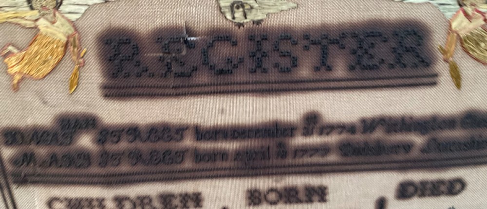 An 1832 Georgian embroidered linen needlework sampler featuring a family register, verse, winged figures, and a floral border. View V