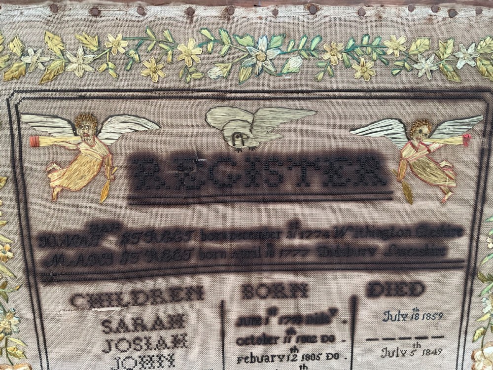 An 1832 Georgian embroidered linen needlework sampler featuring a family register, verse, winged figures, and a floral border. View VI