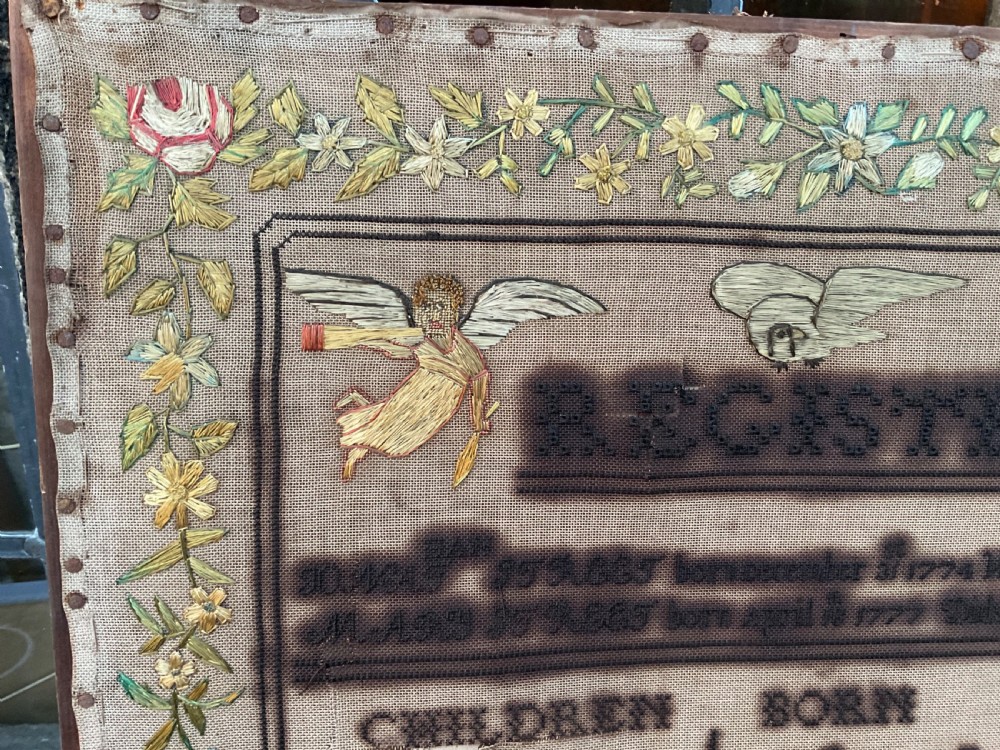 An 1832 Georgian embroidered linen needlework sampler featuring a family register, verse, winged figures, and a floral border. View VIII