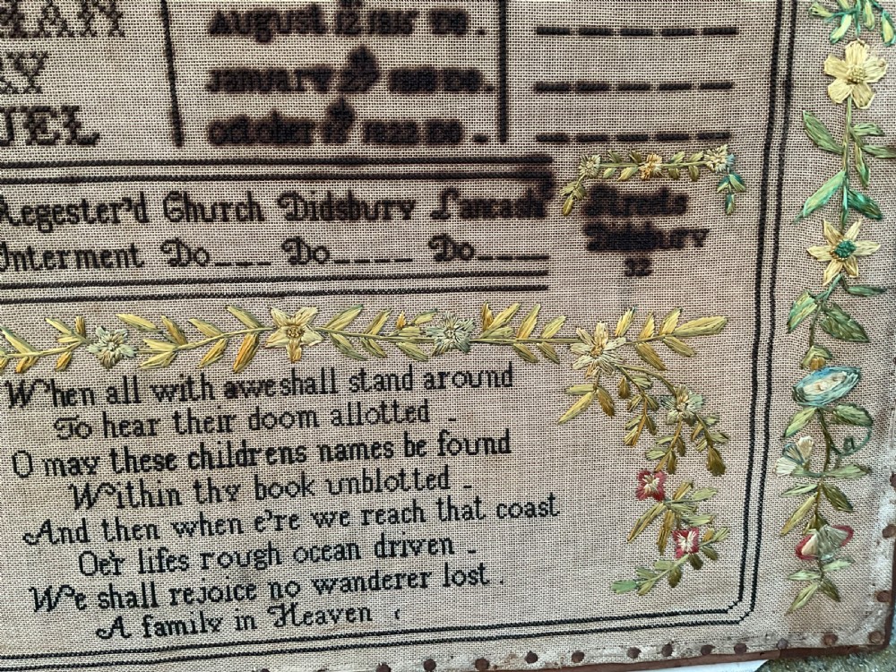 An 1832 Georgian embroidered linen needlework sampler featuring a family register, verse, winged figures, and a floral border. View X
