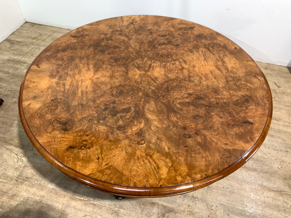 A round Victorian burr walnut coffee table featuring highly figured wood grain on the top and intricately carved cabriole legs. View III