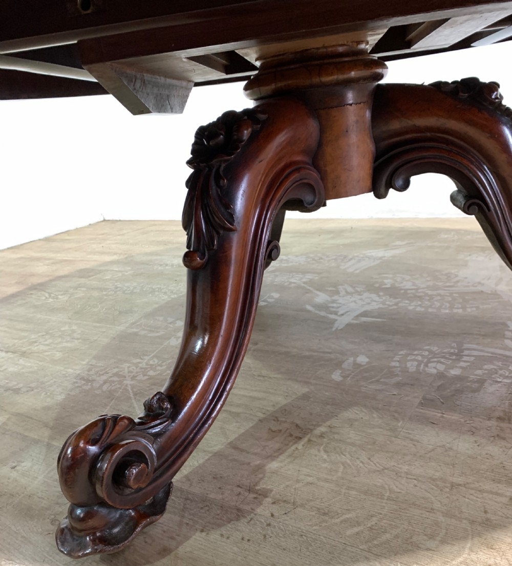 A round Victorian burr walnut coffee table featuring highly figured wood grain on the top and intricately carved cabriole legs. View VII