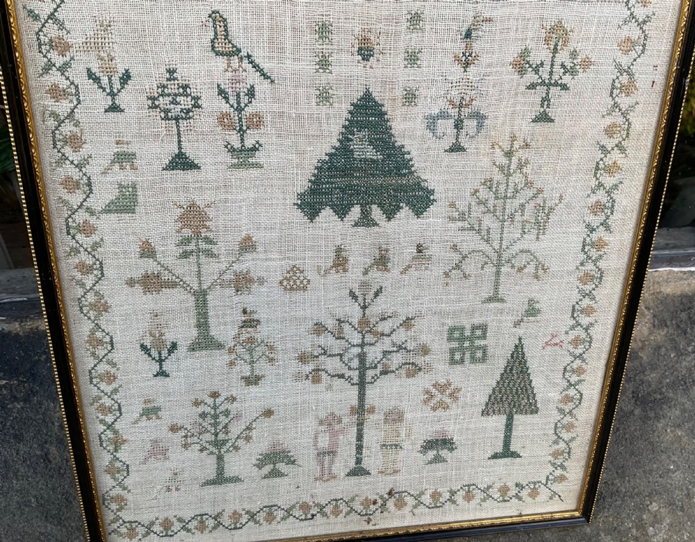 A framed 1810 Georgian linen sampler featuring hand-stitched religious verse, tree motifs, geometric borders, and text reading Sarah Baker Aged 10 August 24 1810. View VI