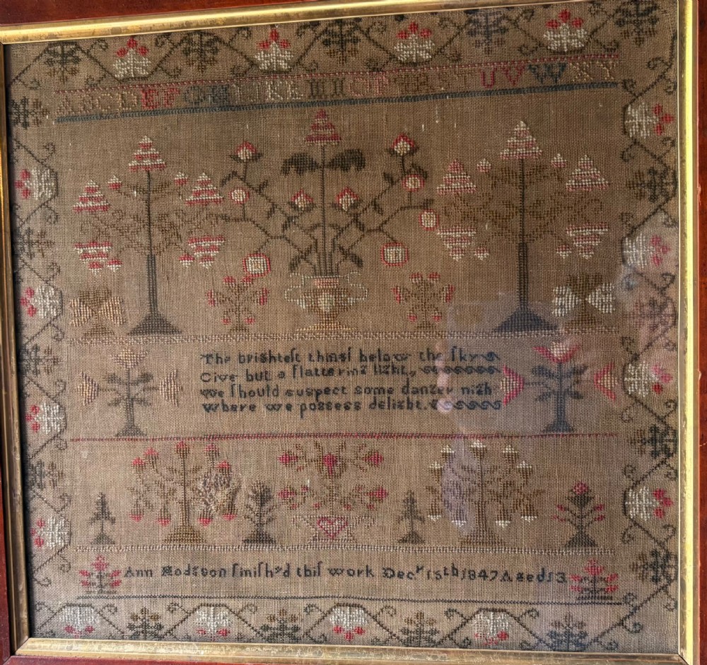 Framed Victorian needlework sampler featuring embroidered alphabets, floral motifs, a central verse, and a signature line dated 1847 set within a wide wooden frame. View II