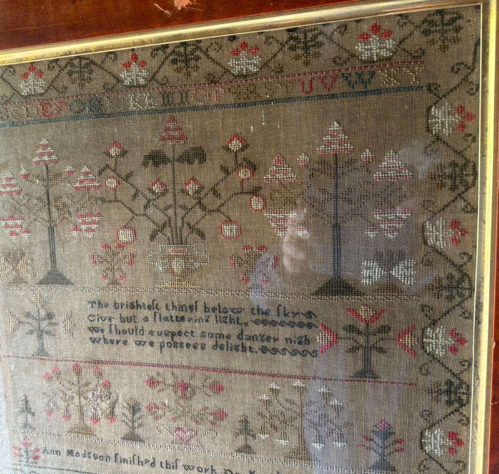 Framed Victorian needlework sampler featuring embroidered alphabets, floral motifs, a central verse, and a signature line dated 1847 set within a wide wooden frame. View VI