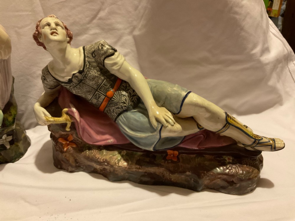A pair of antique ceramic reclining figures depicting Mark Antony and Cleopatra on moulded bases. View II