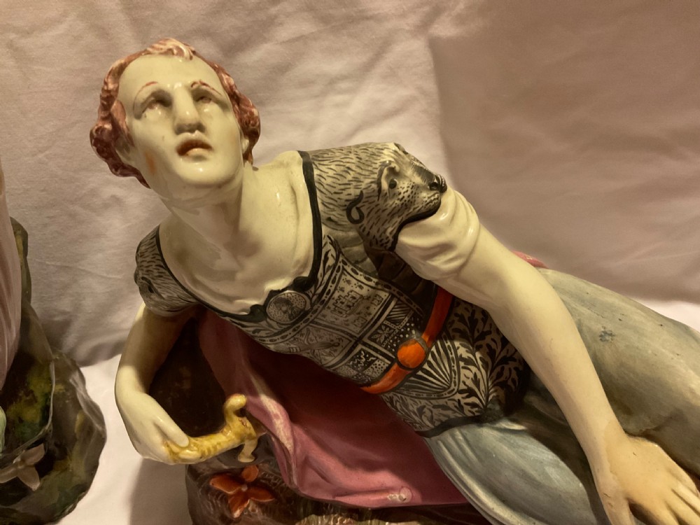 A pair of antique ceramic reclining figures depicting Mark Antony and Cleopatra on moulded bases. View III
