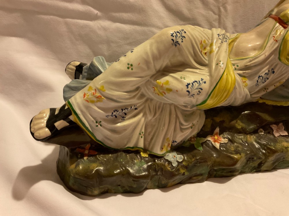 A pair of antique ceramic reclining figures depicting Mark Antony and Cleopatra on moulded bases. View VIII