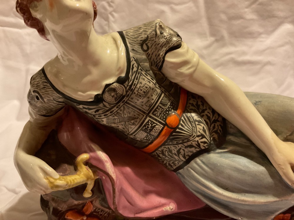 A pair of antique ceramic reclining figures depicting Mark Antony and Cleopatra on moulded bases. View XIII