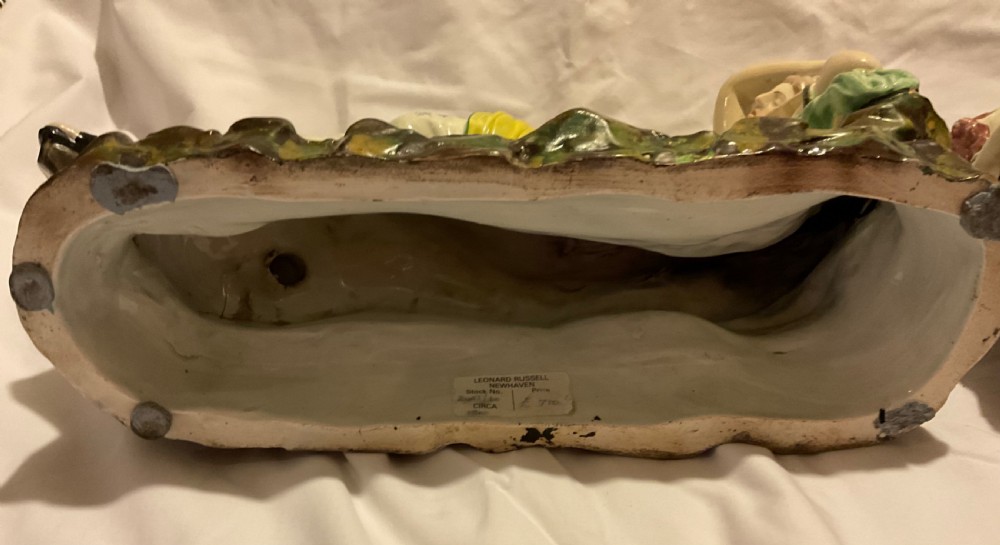 A pair of antique ceramic reclining figures depicting Mark Antony and Cleopatra on moulded bases. View XIX