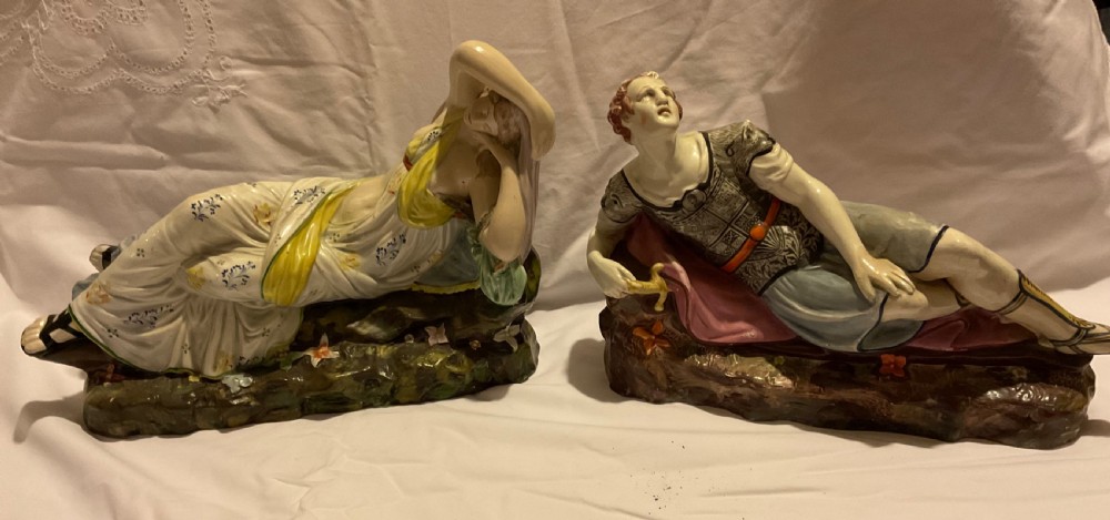 A pair of antique ceramic reclining figures depicting Mark Antony and Cleopatra on moulded bases. View XXIII