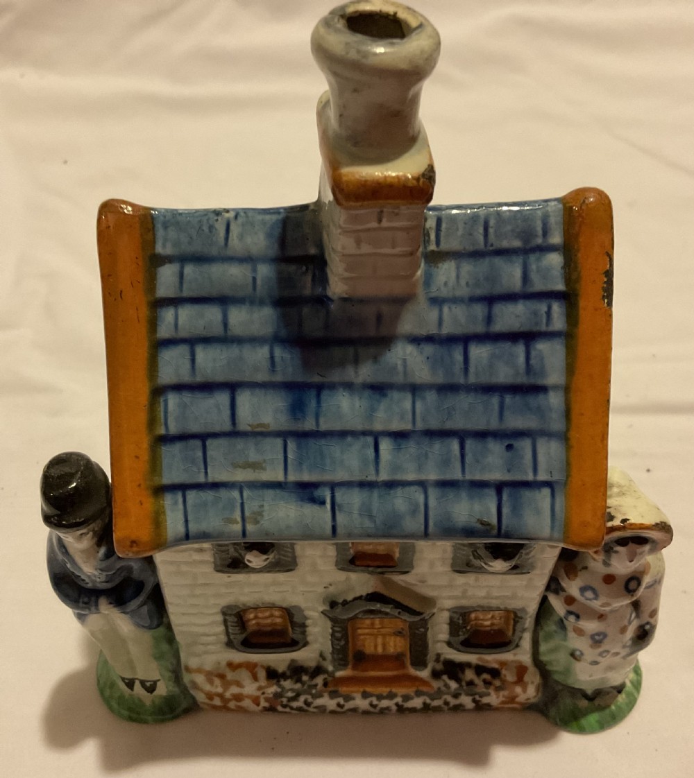 A Regency Prattware earthenware cottage figure featuring a blue tiled roof, central chimney, and relief figures standing on either side. View III