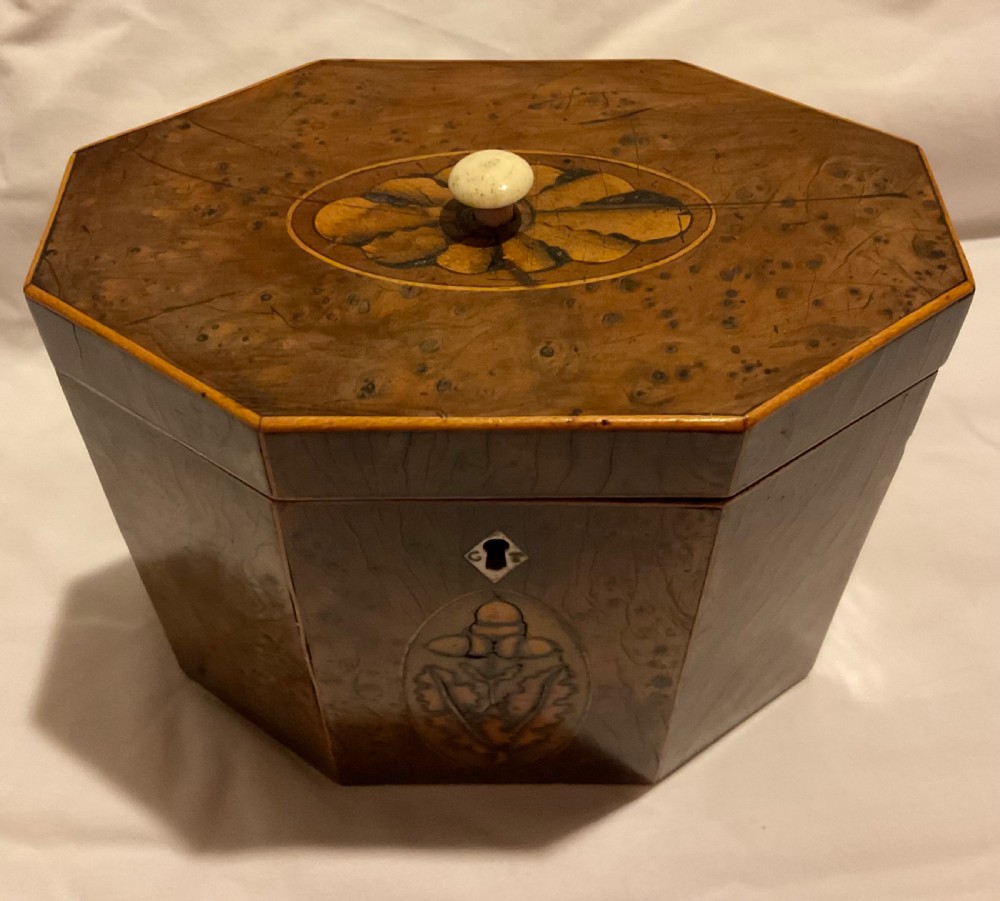 An octagonal Georgian yew wood tea caddy featuring an acorn inlay on the front panel and a bone keyhole escutcheon. View II