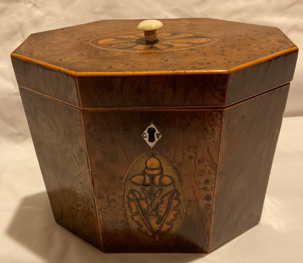 An octagonal Georgian yew wood tea caddy featuring an acorn inlay on the front panel and a bone keyhole escutcheon. View III
