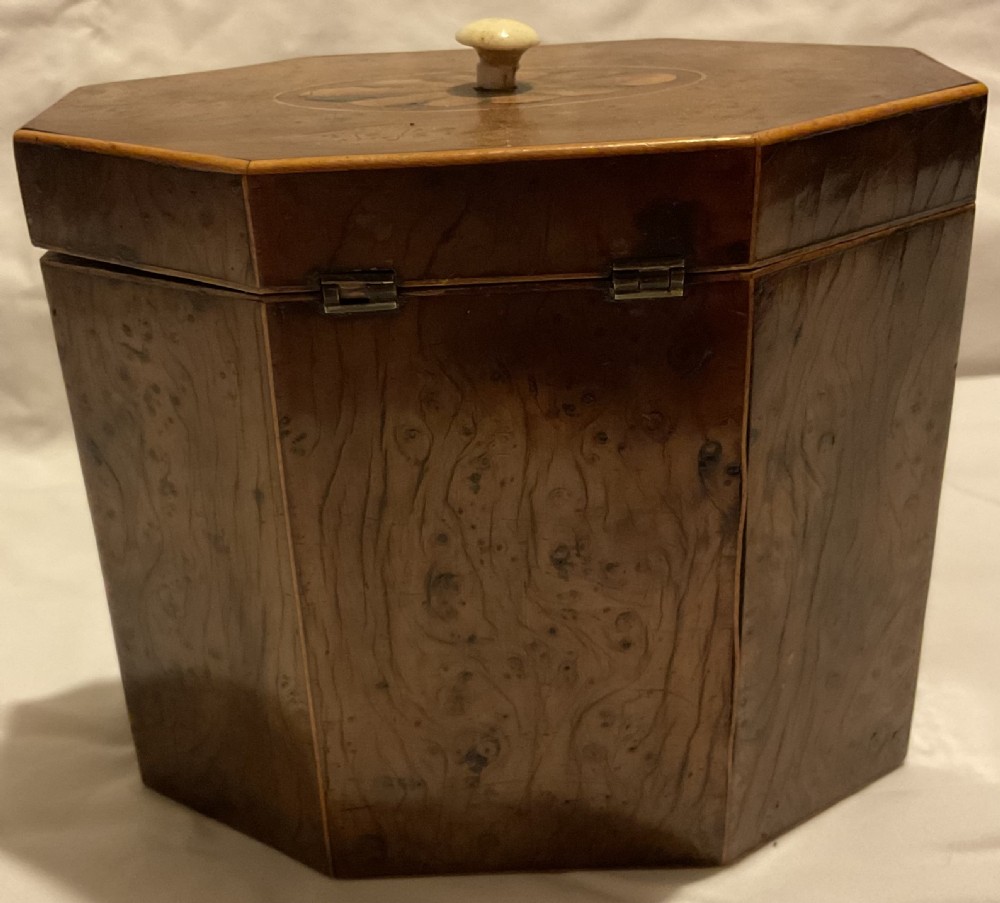 An octagonal Georgian yew wood tea caddy featuring an acorn inlay on the front panel and a bone keyhole escutcheon. View IV