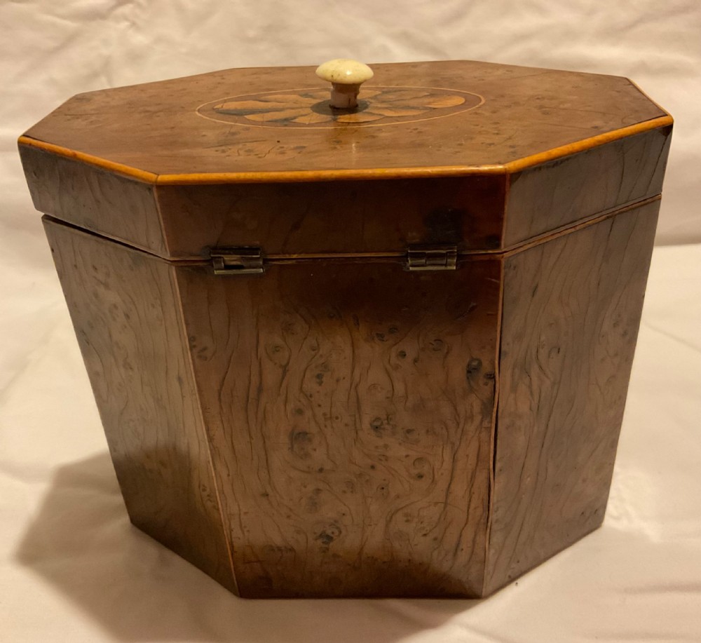 An octagonal Georgian yew wood tea caddy featuring an acorn inlay on the front panel and a bone keyhole escutcheon. View VI