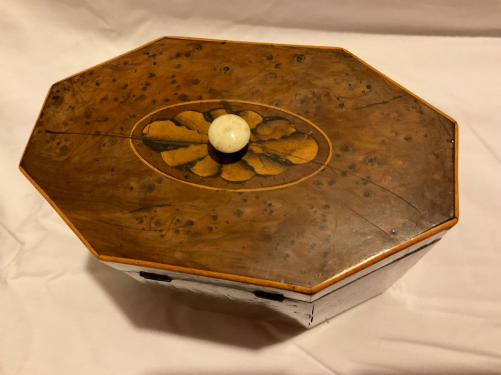 An octagonal Georgian yew wood tea caddy featuring an acorn inlay on the front panel and a bone keyhole escutcheon. View VII