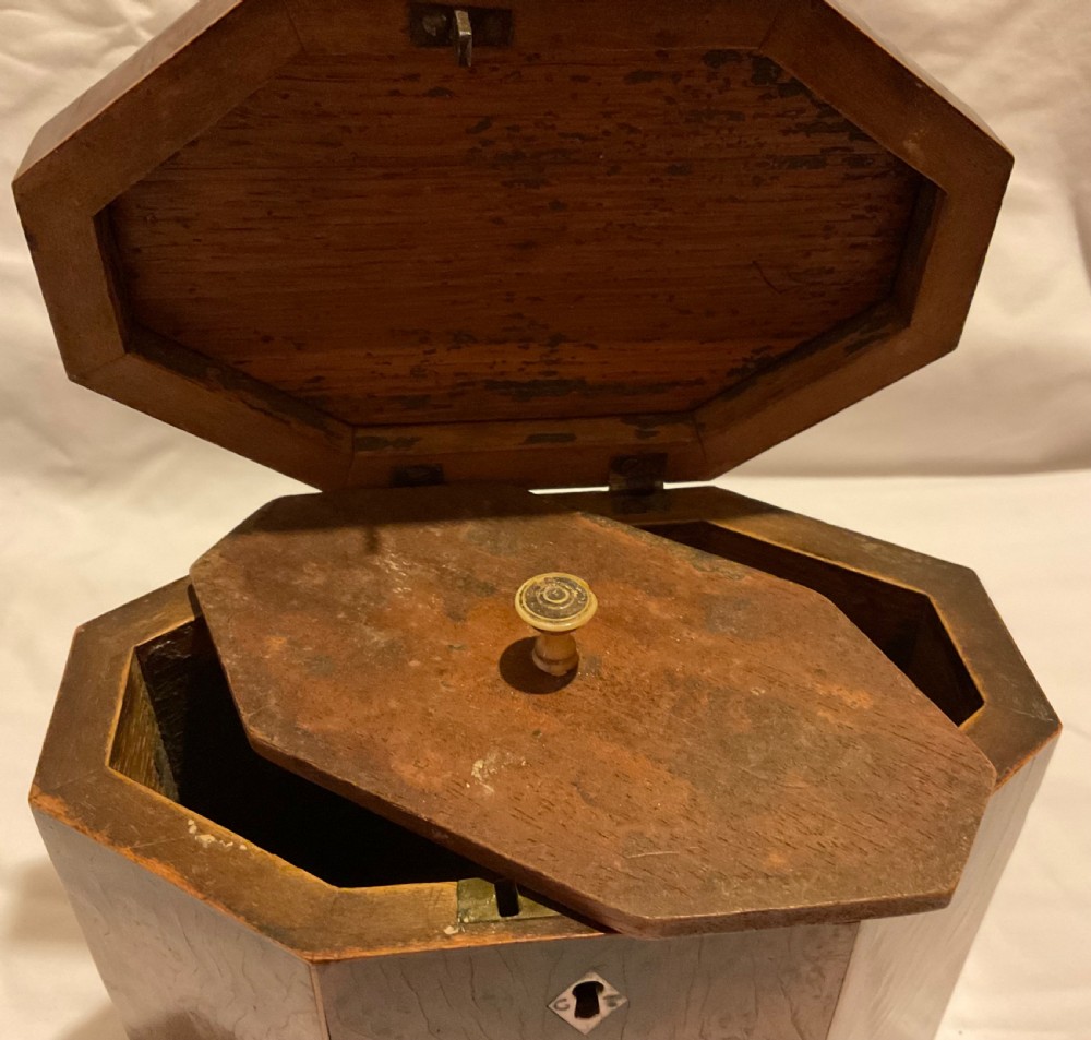 An octagonal Georgian yew wood tea caddy featuring an acorn inlay on the front panel and a bone keyhole escutcheon. View X