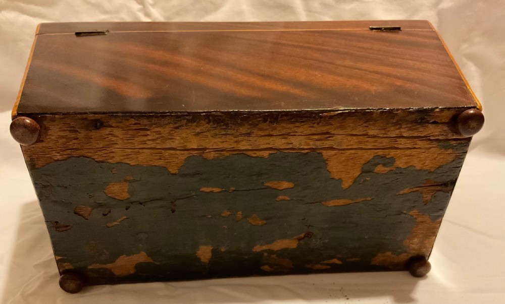 A tapered Georgian mahogany tea caddy with boxwood stringing, top brass handle, and decorative brass keyhole escutcheon. View VIII