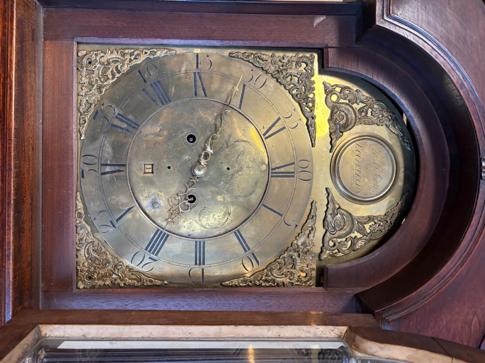 A Georgian mahogany longcase clock featuring a swan-neck pediment, fluted hood columns, and an engraved brass dial. View VIII