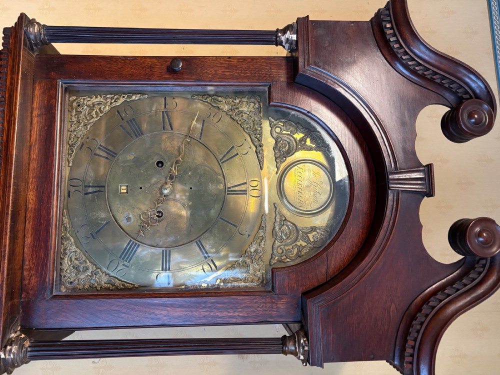 A Georgian mahogany longcase clock featuring a swan-neck pediment, fluted hood columns, and an engraved brass dial. View IX