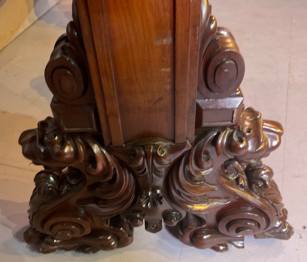 A Victorian three-tiered mahogany metamorphic dumb waiter featuring rounded shelf edges and carved scroll feet. View IX