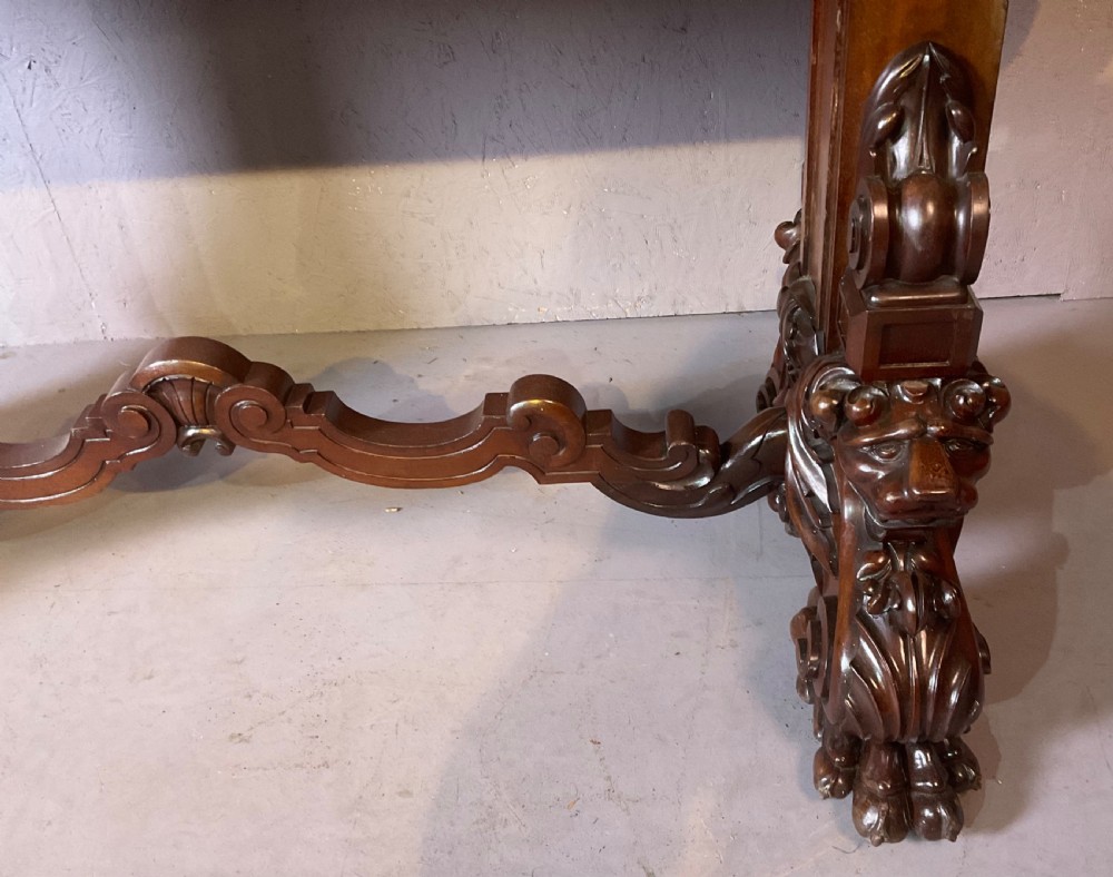 A Victorian three-tiered mahogany metamorphic dumb waiter featuring rounded shelf edges and carved scroll feet. View X