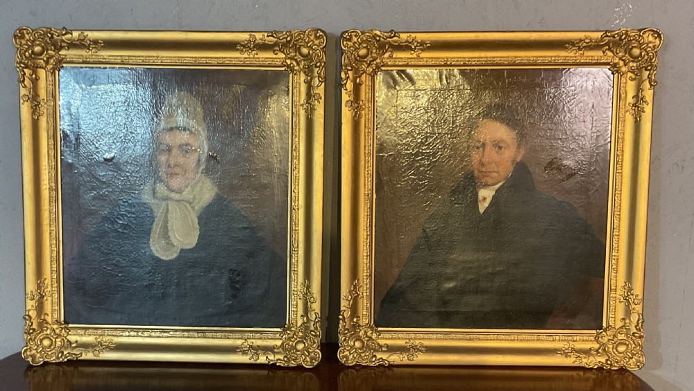 A pair of Regency period oil paintings on canvas depicting a gentleman and a lady in matching ornate gold gilt frames. View II