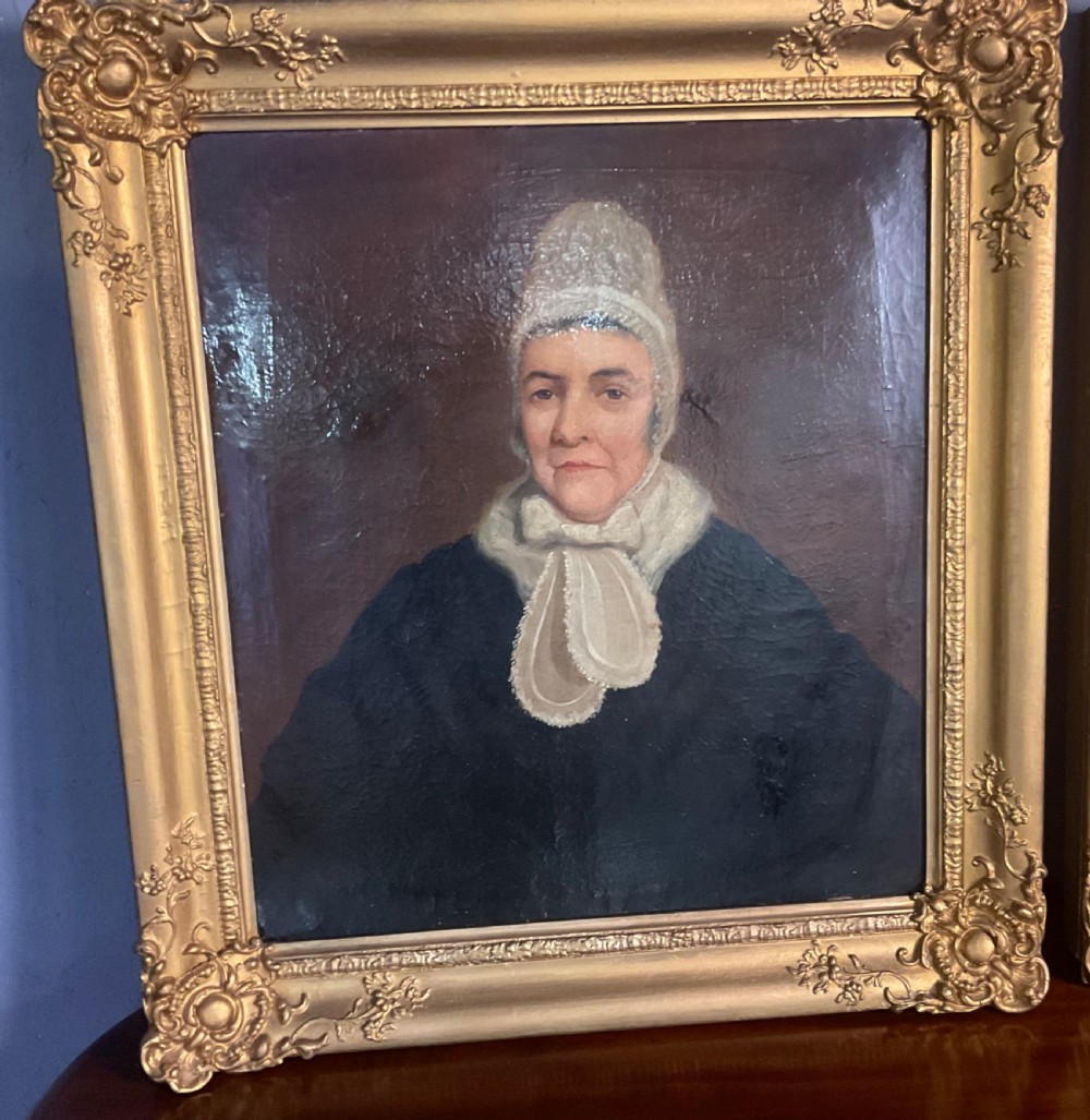 A pair of Regency period oil paintings on canvas depicting a gentleman and a lady in matching ornate gold gilt frames. View VI