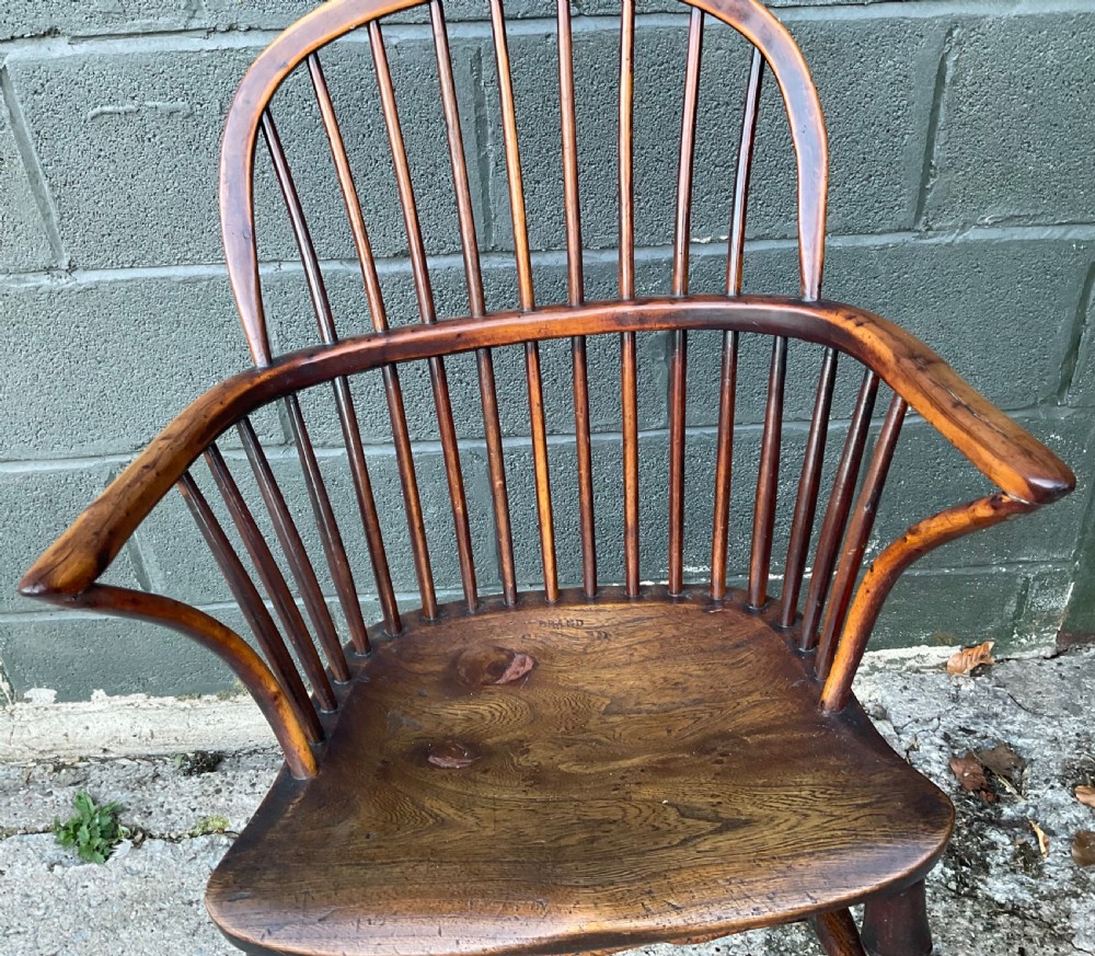 An antique yew wood Windsor armchair featuring a hoop back with vertical spindles, shaped arms, and turned wooden legs. View IX