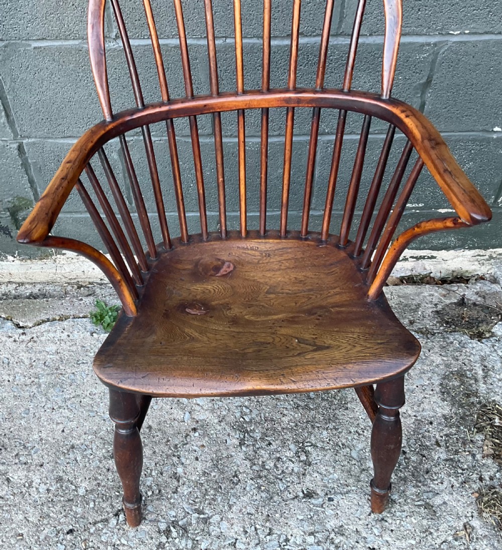 An antique yew wood Windsor armchair featuring a hoop back with vertical spindles, shaped arms, and turned wooden legs. View XI