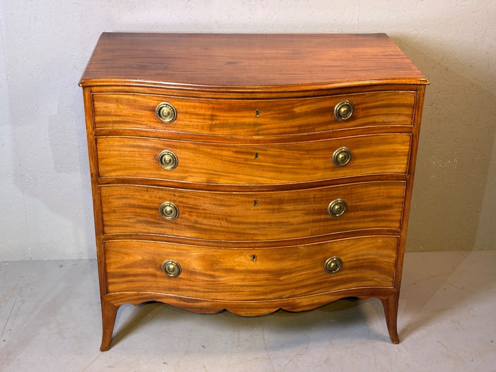 A Georgian serpentine chest of drawers in mahogany View II
