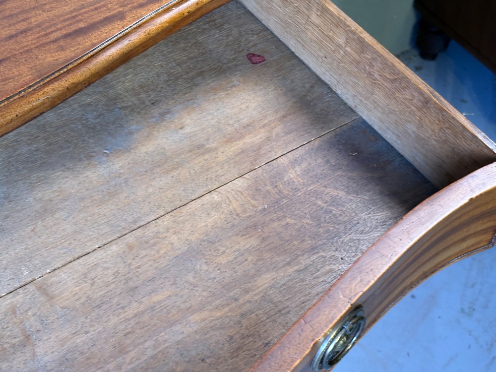 A Georgian serpentine chest of drawers in mahogany View VIII
