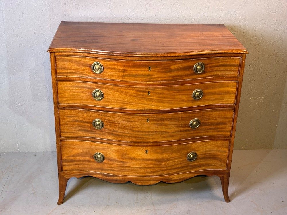 A Georgian serpentine chest of drawers in mahogany View IX