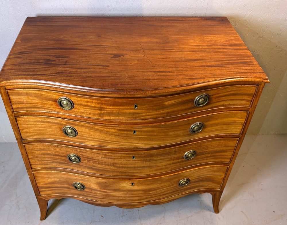 A Georgian serpentine chest of drawers in mahogany View X