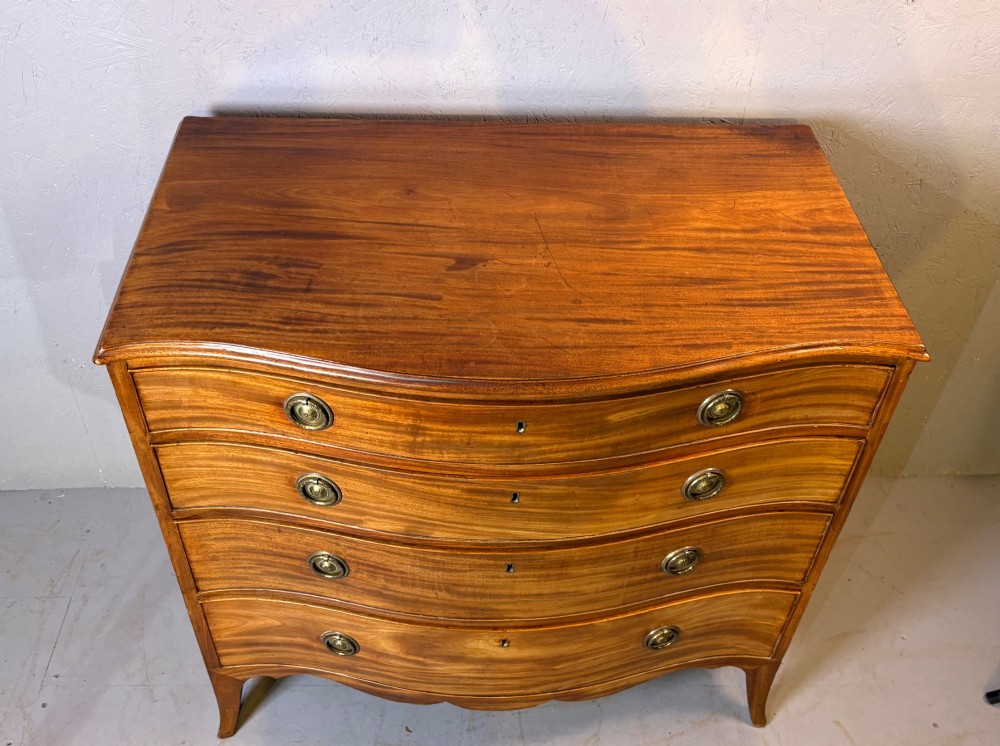 A Georgian serpentine chest of drawers in mahogany View XI