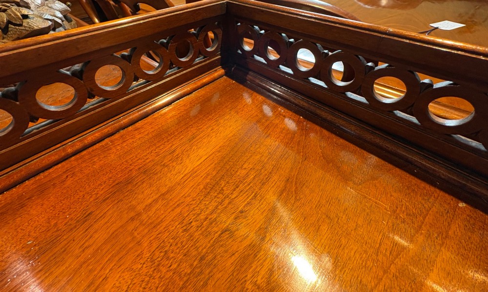 A nineteenth-century mahogany pedestal desk featuring nine drawers with turned wooden handles and a carved pierced gallery top. View VIII