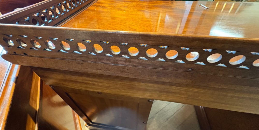 A nineteenth-century mahogany pedestal desk featuring nine drawers with turned wooden handles and a carved pierced gallery top. View XI