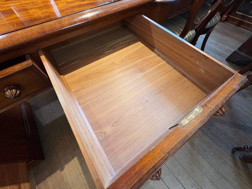 A nineteenth-century mahogany pedestal desk featuring nine drawers with turned wooden handles and a carved pierced gallery top. View XII