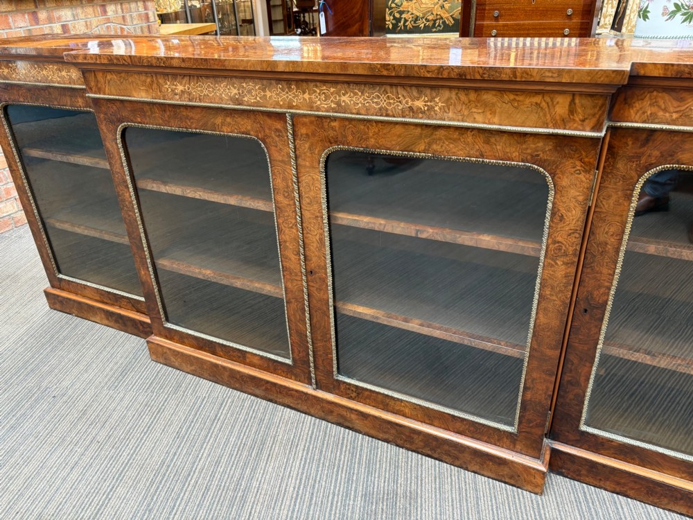 A  Victorian burr walnut and marquetry inlaid low long bookcase View III