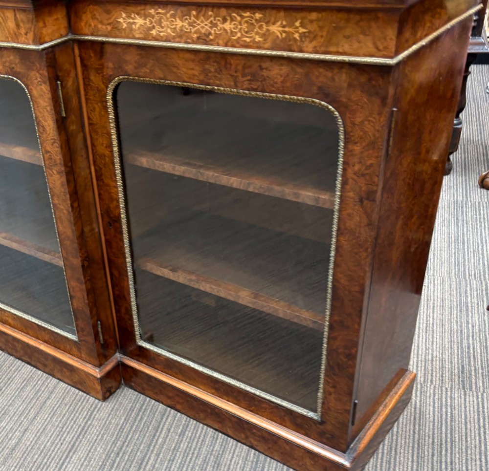 A  Victorian burr walnut and marquetry inlaid low long bookcase View V
