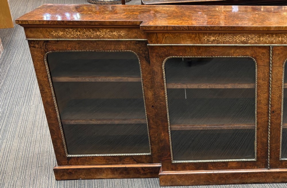 A  Victorian burr walnut and marquetry inlaid low long bookcase View VII